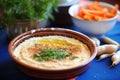 roasted garlic hummus with cloves around the bowl edge Royalty Free Stock Photo