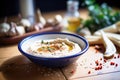 roasted garlic hummus with cloves around the bowl edge Royalty Free Stock Photo