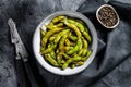 Roasted green edamame soybeans, japanese food. Black background. Top view