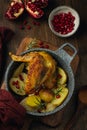 Roasted guinea fowl with pomegranate, rosemary and baked potatoes