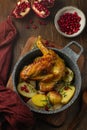 Roasted guinea fowl with pomegranate, rosemary and baked potatoes