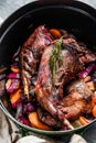 Roasted hare Haunches in stewpot with Stewed  Vegetables. Cooking stew. Top view Royalty Free Stock Photo