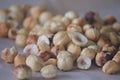 Roasted hazelnuts in a rustic scatter featuring whole and split filbert kernels with natural skin Royalty Free Stock Photo