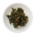Roasted kale chips in a bowl isolated on white background Royalty Free Stock Photo