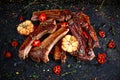 Roasted lamb cutlets ribs with garlic and herbs on stone background Royalty Free Stock Photo