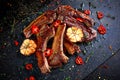 Roasted lamb cutlets ribs with garlic and herbs on stone background Royalty Free Stock Photo