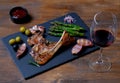 Roasted lamb ribs with olives asparagus and glass of red wine Royalty Free Stock Photo