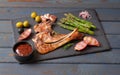Roasted lamb ribs with olives, asparagus, onions and garlic Royalty Free Stock Photo