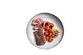 Roasted Lamb tenderloin meat in plate with grilled tomato and garlic, mutton sirloin fillet steak. High quality Isolate Royalty Free Stock Photo