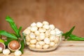 Roasted macadamia nut in glass bowl on wooden table