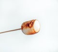 Roasted marshmallows on a skewer on white background Royalty Free Stock Photo