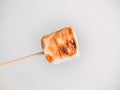 Roasted marshmallows on a skewer on white background Royalty Free Stock Photo