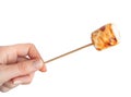 Roasted marshmallows on a skewer on white background Royalty Free Stock Photo