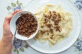 Roasted meat in a bowl . A bowl of white ceramic salt and pepper . Traditional azerbaijani khingal with force-meat on the