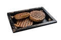 Roasted meat free patties, plant based meat burger cutlets in wooden tray with herbs. Isolated on white background. Top Royalty Free Stock Photo