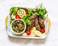 Roasted meat kebab , grilled vegetables sauce, zucchini, flatbread, green salad - delicious mediterranean style lunch on a light Royalty Free Stock Photo