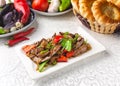 Roasted meat with red and green bell peppers. Traditional oriental dish. Royalty Free Stock Photo