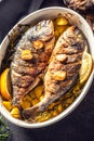 Roasted mediterranean fish bream with potatoes rosemary and lemon