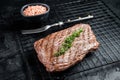 Roasted medium rare flank beef steak with thyme. Black background. Top view Royalty Free Stock Photo