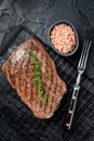 Roasted medium rare flank beef steak with thyme. Black background. Top view Royalty Free Stock Photo