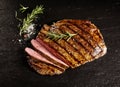 Roasted medium rare sliced flank beef with rosemary