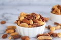 Roasted mixed nuts in white ceramic bowl