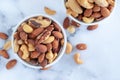 Roasted mixed nuts in white ceramic bowl