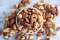 Roasted mixed nuts in white ceramic bowl