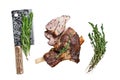 Roasted mutton lamb leg sliced in a wooden tray with meat cleaver. Isolated, white background.