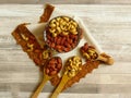 Roasted Natural Almond Nuts Badam and Cashew in a porcelain bowl.