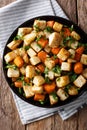 Roasted organic celery root and carrots close-up on a plate. Vertical top view Royalty Free Stock Photo