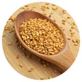 Roasted organic sesame seeds, in wooden spoon on bamboo cutting board Royalty Free Stock Photo