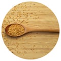 Roasted organic sesame seeds, in wooden spoon on bamboo cutting board Royalty Free Stock Photo