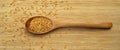 Roasted organic sesame seeds, in wooden spoon on bamboo cutting board Royalty Free Stock Photo