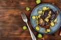Grilled ostrich steak with kiwi berries