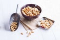 Roasted peanuts on a bowl over white wooden background Royalty Free Stock Photo