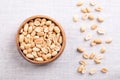 Roasted peanuts in a wooden bowl on linen fabric Royalty Free Stock Photo