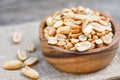 Roasted peanuts on a wooden bowl and sack background - salted peanuts as a food or snack Royalty Free Stock Photo