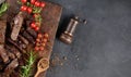 Roasted piece of beef ribeye cut into pieces on a vintage brown chopping board. Delicious steak, copy space Royalty Free Stock Photo