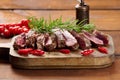 Roasted piece of beef ribeye cut into pieces on a vintage brown chopping board. Well done. Appetizing steak Royalty Free Stock Photo