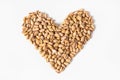 Roasted pistachios are located on a white background in the form of a heart. Nuts are good for the heart. Isolated