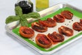 Roasted Plum tomatoes on a baking sheet.  Macro with selective focus on front tomatoes Royalty Free Stock Photo