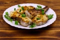 Roasted pollock in white plate on wooden table