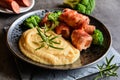 Roasted pork cutlets wrapped in bacon and stuffed with sausage, served with peas puree