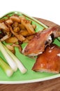 Roasted pork, french fries and young onion in the plate Royalty Free Stock Photo