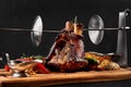 Roasted pork knuckle eisbein with braised boiled cabbage, potatoes, chili peppers and mustard on wooden cutting board Royalty Free Stock Photo