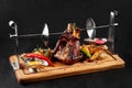 Roasted pork knuckle eisbein with braised boiled cabbage, potatoes, chili peppers and mustard on wooden cutting board Royalty Free Stock Photo