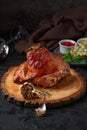 Roasted pork knuckle eisbein with cabbage and mustard on wooden cutting board Royalty Free Stock Photo