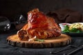 Roasted pork knuckle eisbein with cabbage and mustard on wooden cutting board Royalty Free Stock Photo