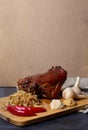 Roasted pork knuckle with stewed cabbage and vegetables on board Royalty Free Stock Photo